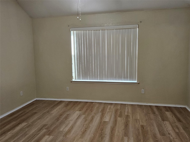 unfurnished room with wood-type flooring