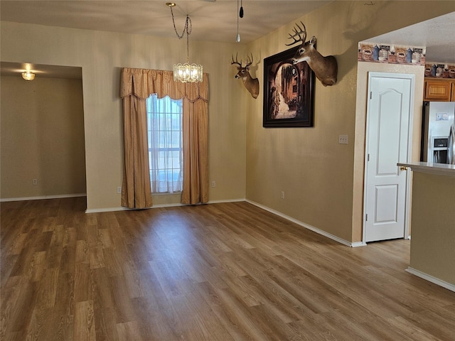 interior space featuring hardwood / wood-style floors and an inviting chandelier