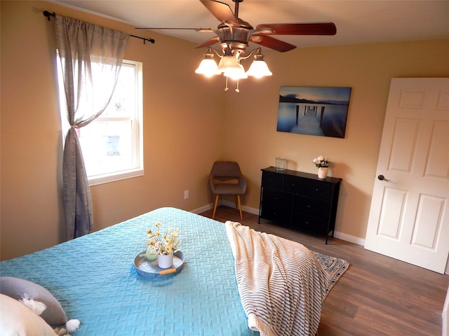 bedroom with ceiling fan and dark hardwood / wood-style flooring