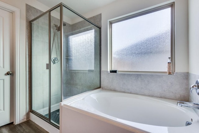 bathroom with plus walk in shower and wood-type flooring