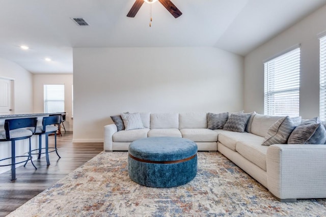 living room featuring ceiling fan, plenty of natural light, dark wood-type flooring, and lofted ceiling