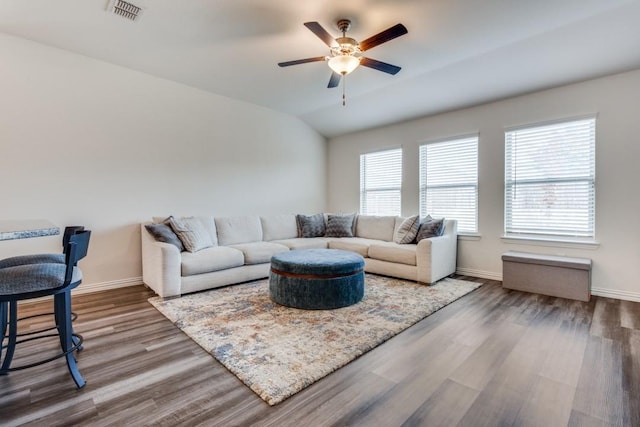 living room featuring hardwood / wood-style flooring, vaulted ceiling, and ceiling fan