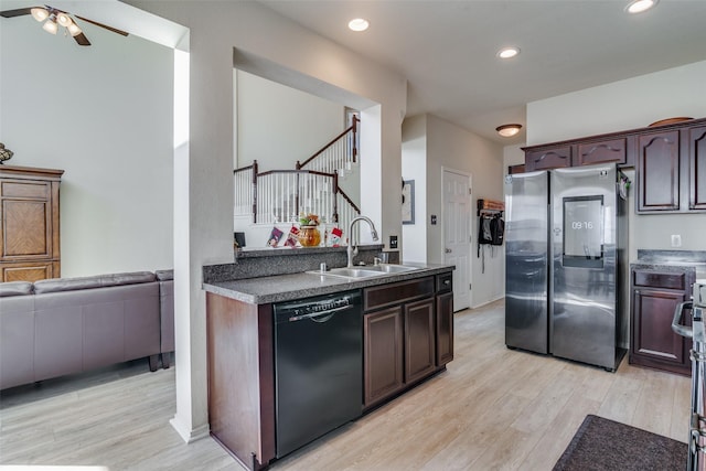 kitchen with stainless steel refrigerator, dark brown cabinetry, black dishwasher, and sink