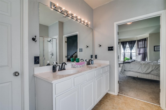 bathroom featuring vanity, tile patterned floors, and walk in shower