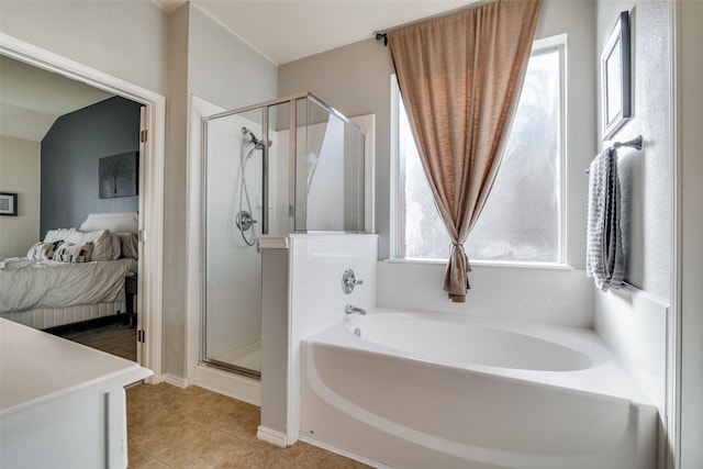 bathroom with tile patterned floors and separate shower and tub