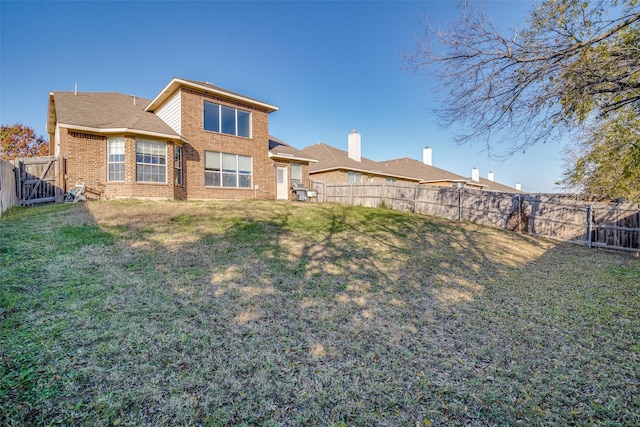 back of property featuring a lawn