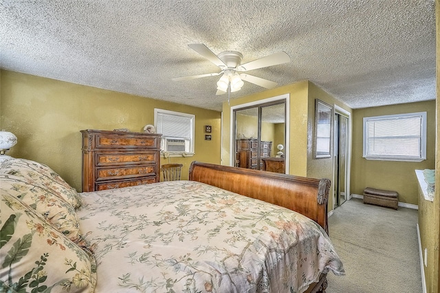 carpeted bedroom featuring ceiling fan, a textured ceiling, and a closet