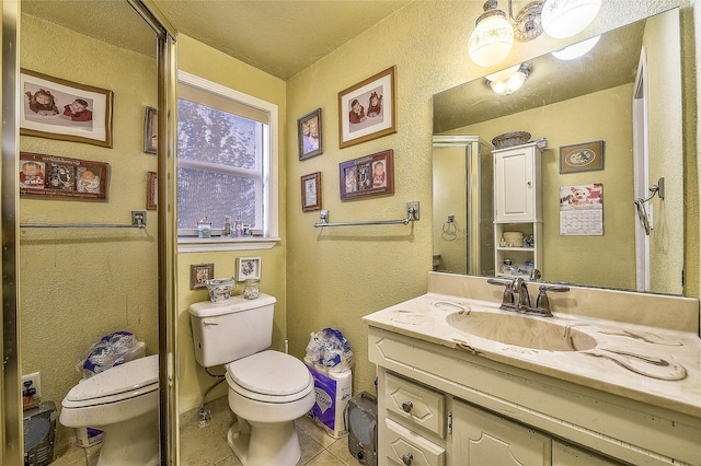 bathroom featuring tile patterned floors, a textured ceiling, toilet, vanity, and a shower with shower door