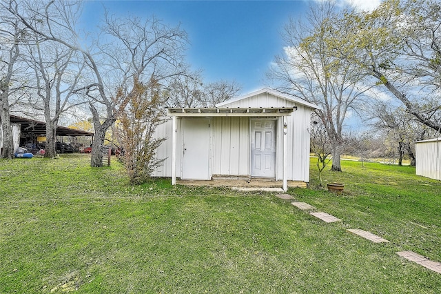 view of outbuilding featuring a lawn