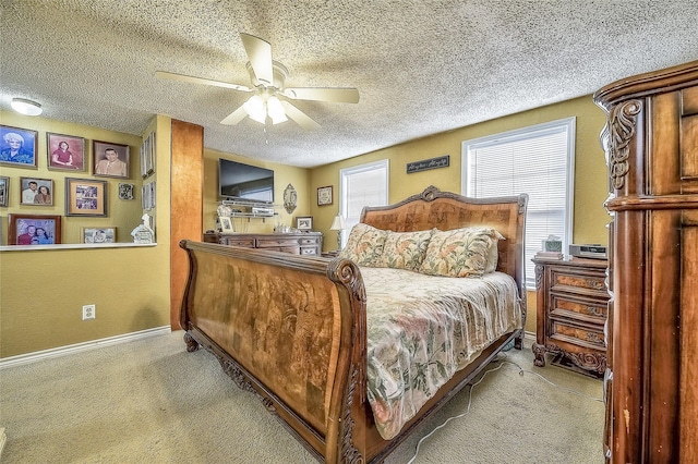 carpeted bedroom with ceiling fan and a textured ceiling