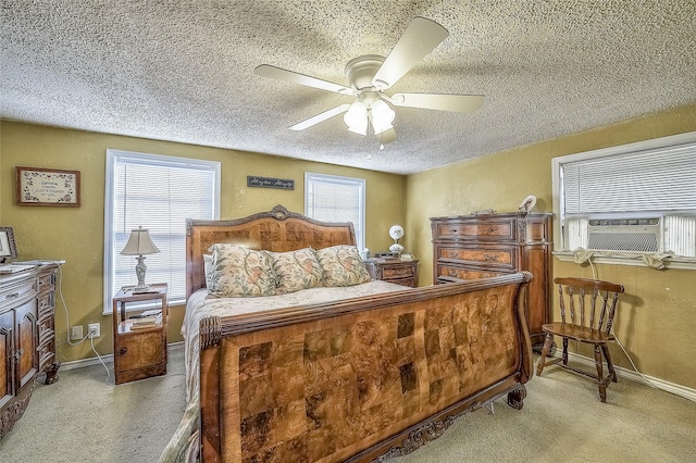 bedroom with light carpet, a textured ceiling, ceiling fan, and cooling unit