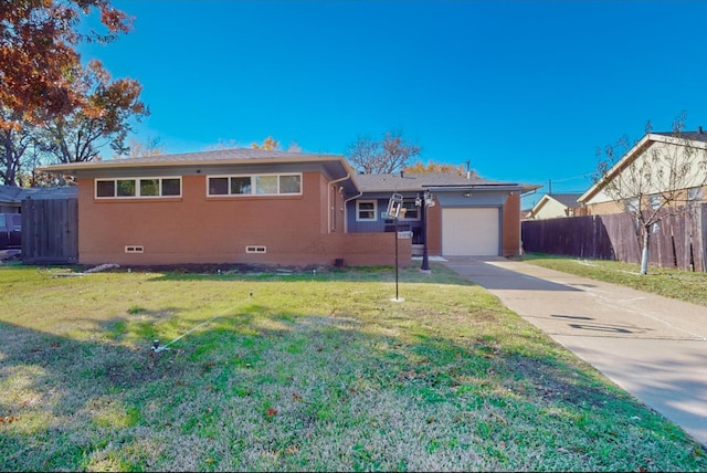 view of front of property featuring a garage and a front lawn