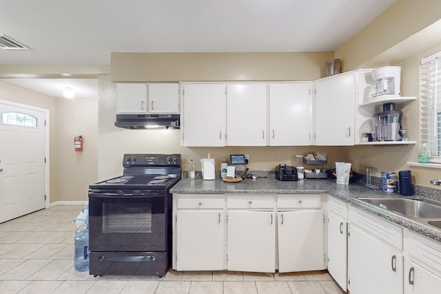 kitchen featuring electric range, plenty of natural light, and white cabinets