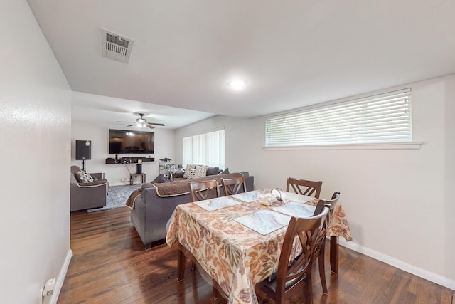 dining room with ceiling fan and dark wood-type flooring