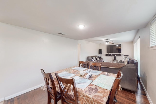 dining space with dark hardwood / wood-style flooring and ceiling fan