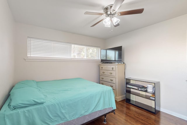 bedroom with ceiling fan and dark hardwood / wood-style flooring