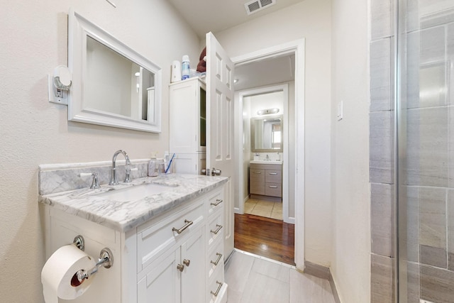 bathroom featuring vanity and hardwood / wood-style flooring