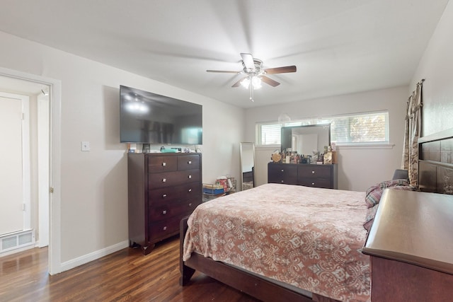 bedroom with dark hardwood / wood-style floors and ceiling fan