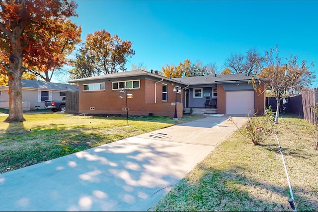 ranch-style home with a garage and a front lawn