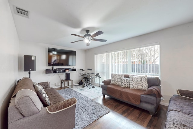 living room featuring ceiling fan and wood-type flooring