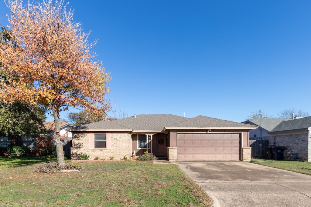 single story home with a garage and a front yard