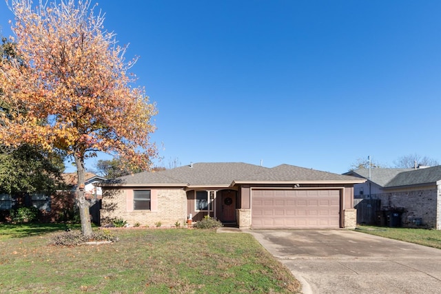 ranch-style house featuring a garage and a front lawn