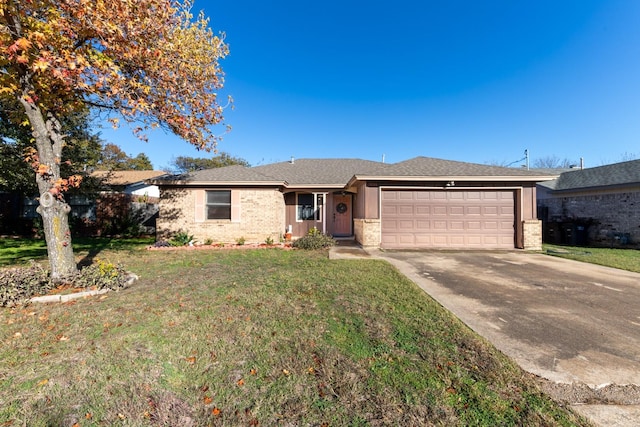 ranch-style house featuring a front yard and a garage