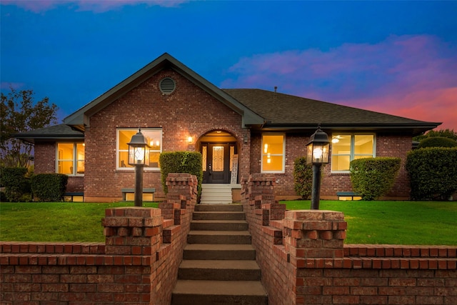 view of front of property with a yard