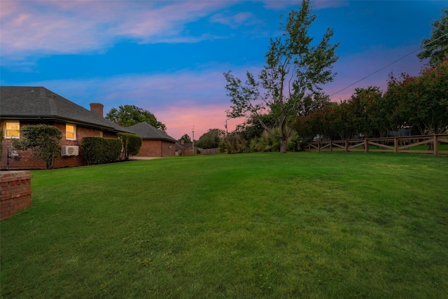 view of yard at dusk