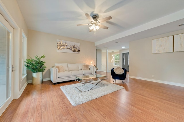 living room featuring light hardwood / wood-style floors and ceiling fan