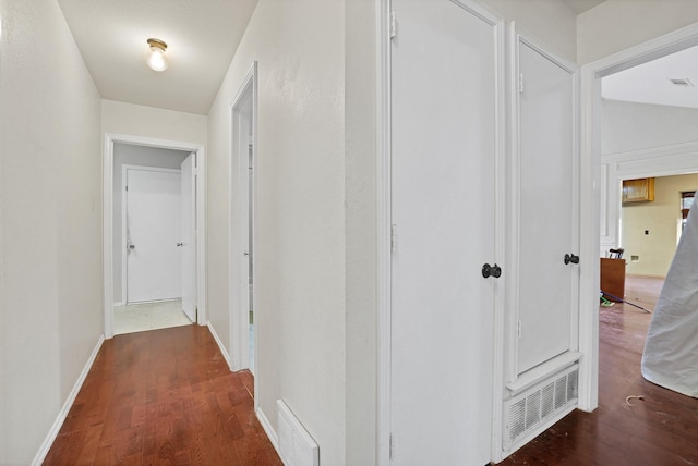 corridor featuring dark hardwood / wood-style flooring