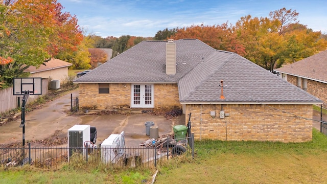 back of house featuring central air condition unit, french doors, and a patio