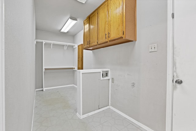 clothes washing area featuring cabinets and washer hookup