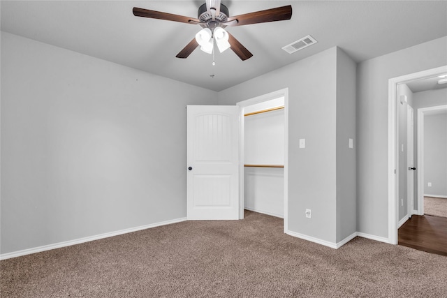 unfurnished bedroom featuring ceiling fan, a closet, and carpet floors