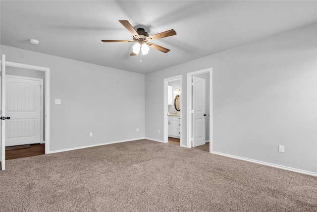 unfurnished bedroom with ceiling fan, carpet floors, and ensuite bath