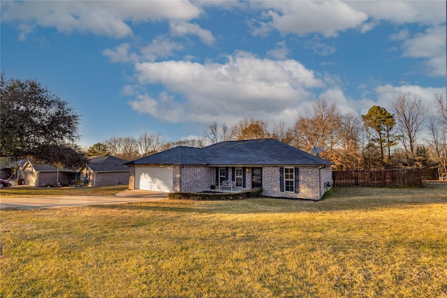 ranch-style home featuring a front lawn and a garage