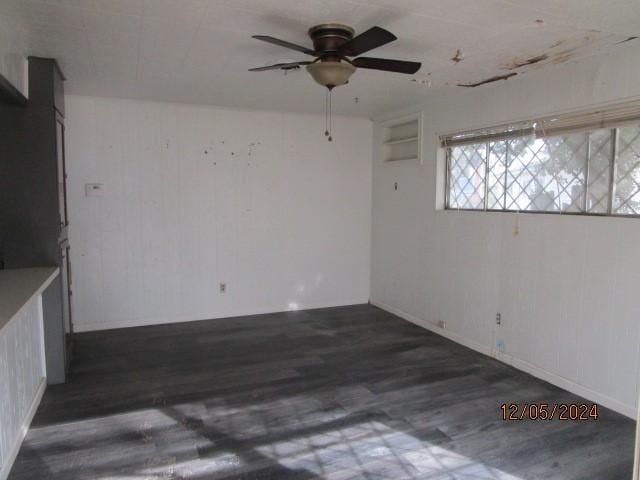 unfurnished room featuring ceiling fan and dark hardwood / wood-style flooring