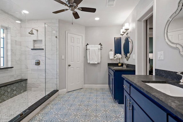 bathroom with a tile shower, ceiling fan, and vanity