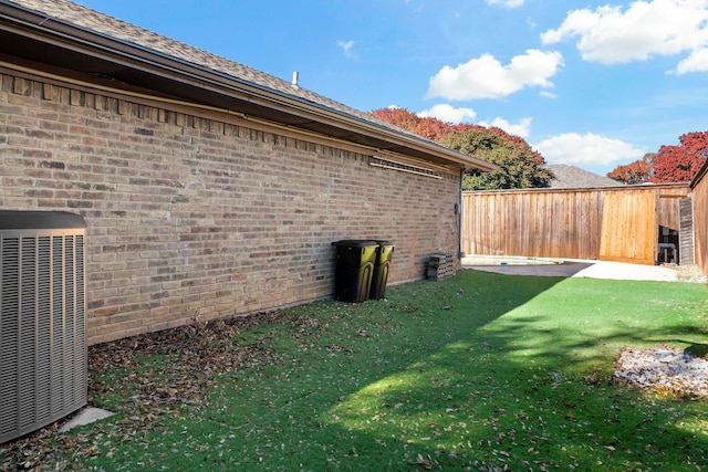 view of property exterior featuring a yard and central AC