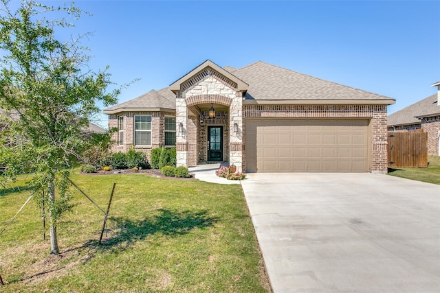 view of front of property featuring a front yard and a garage