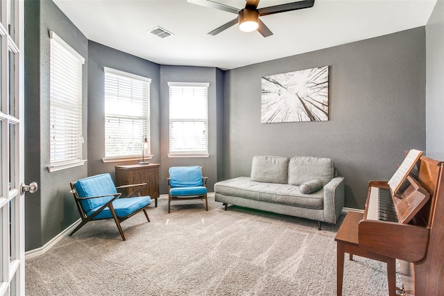 sitting room with carpet and ceiling fan