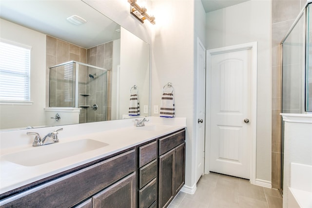 bathroom with tile patterned floors, vanity, and walk in shower