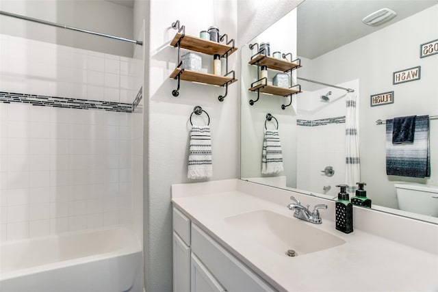 full bathroom with vanity, toilet, and tiled shower / bath combo