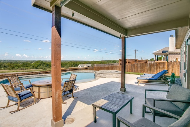 view of patio / terrace featuring a pool with hot tub