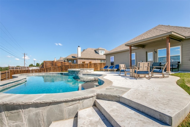 view of pool with a jacuzzi and a patio