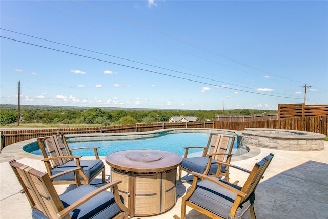 view of pool featuring an in ground hot tub