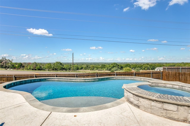 view of swimming pool with an in ground hot tub