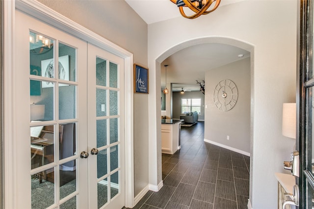 hallway featuring dark hardwood / wood-style floors and french doors