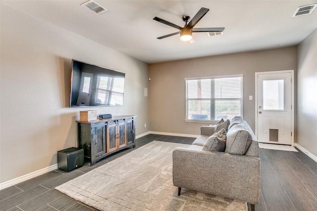 living room featuring a wealth of natural light and ceiling fan