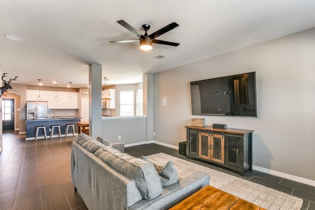 living room with ceiling fan and sink